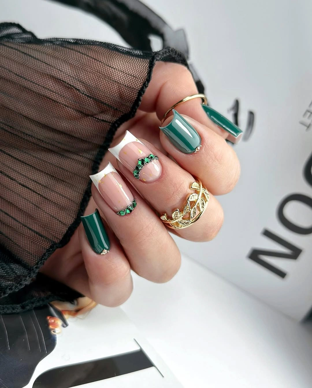 Long square emerald and pink nails with white tips and sparkling green bands