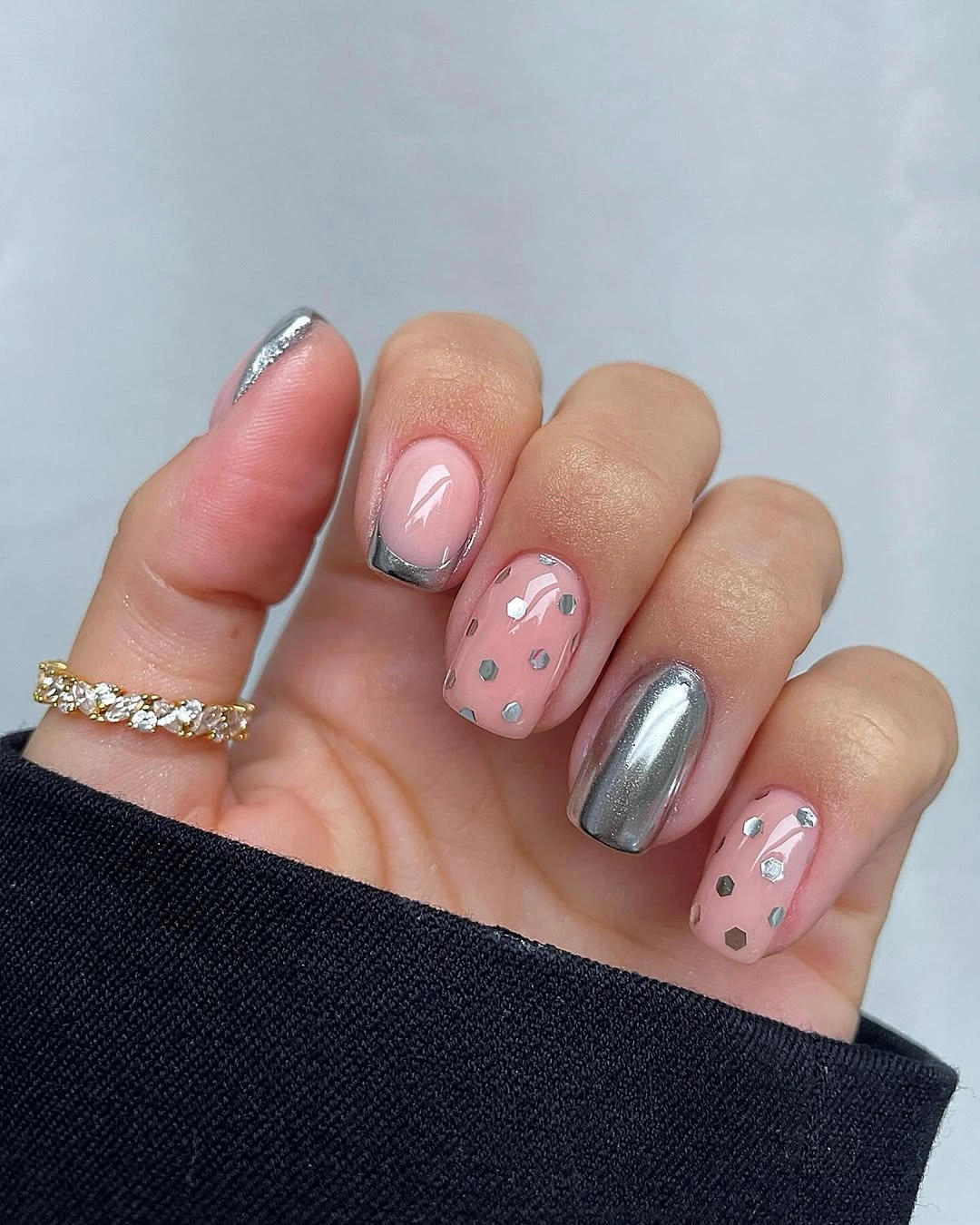 Pink rounded-square nails with silver edges, hexagonal accents, and mirror finish