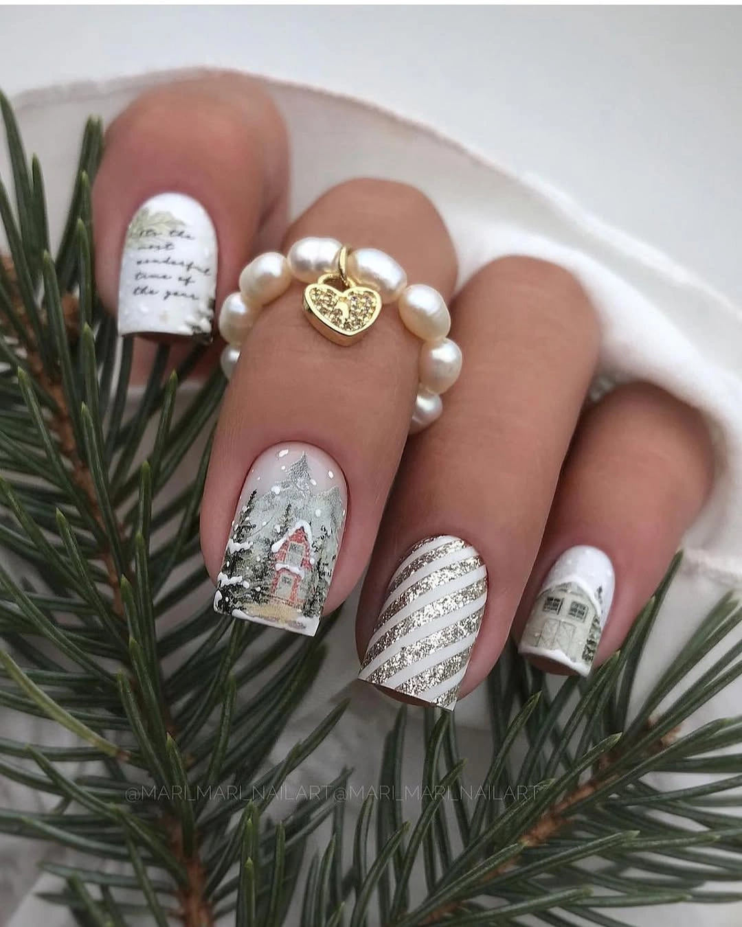 Square white nails with snowy buildings, evergreens, script, and silver stripes
