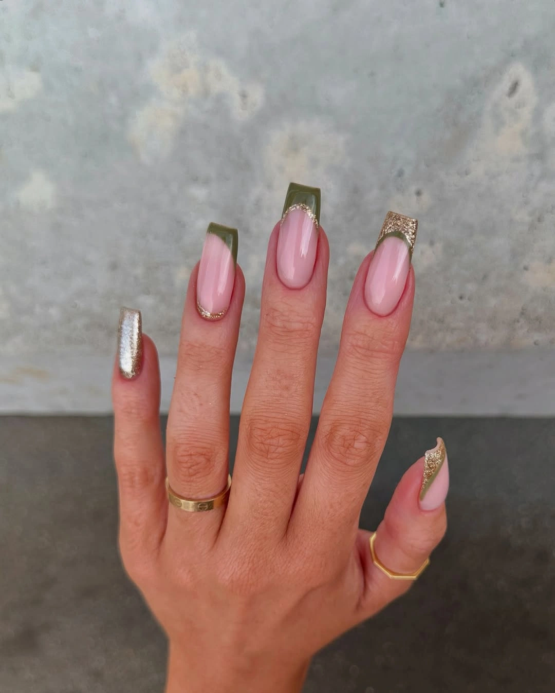Long square pink nails with olive tips and champagne glitter accents