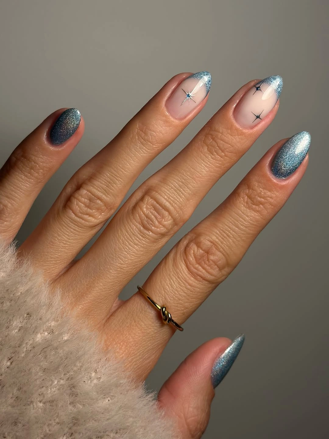 Short steel blue shimmer nails with glitter French tips and tiny stars