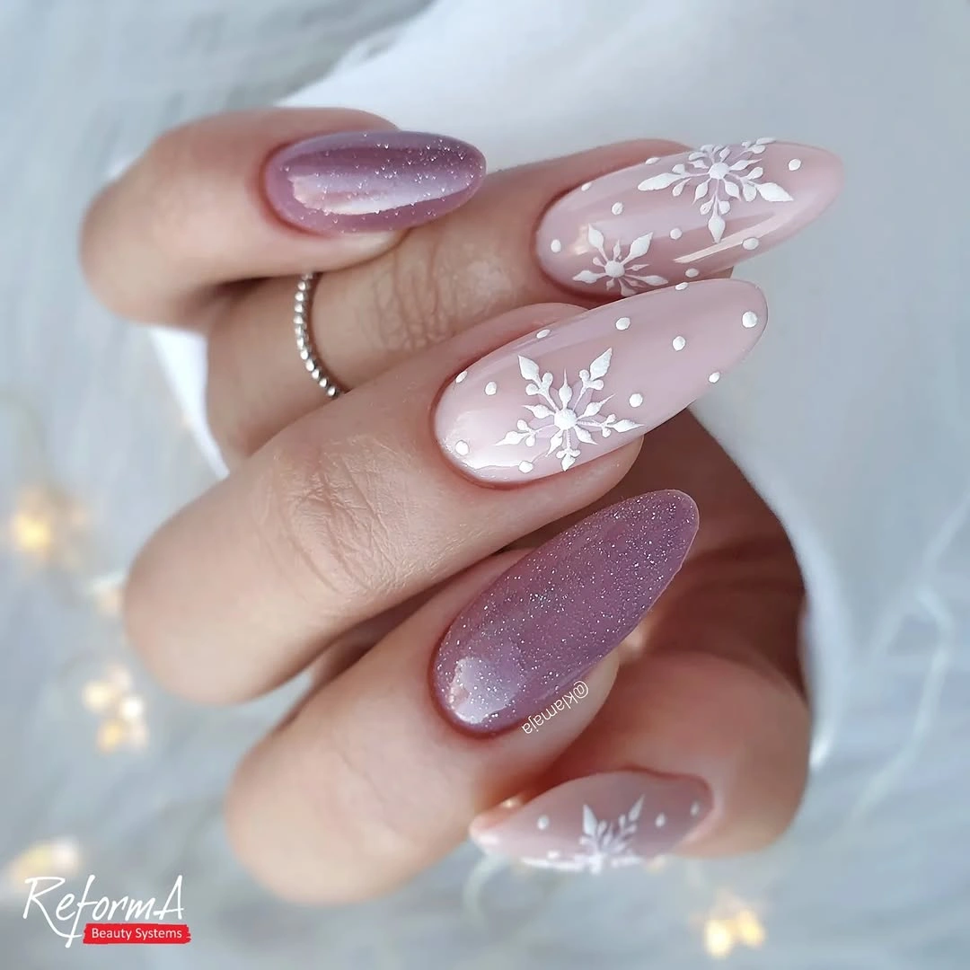 Long almond lavender shimmer nails with pink bases and white snowflakes